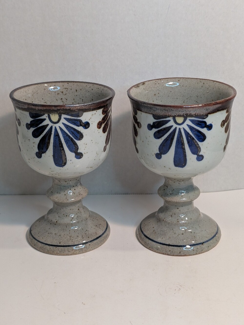 Two vintage stoneware goblets speckled beige glaze with a Floral Design.